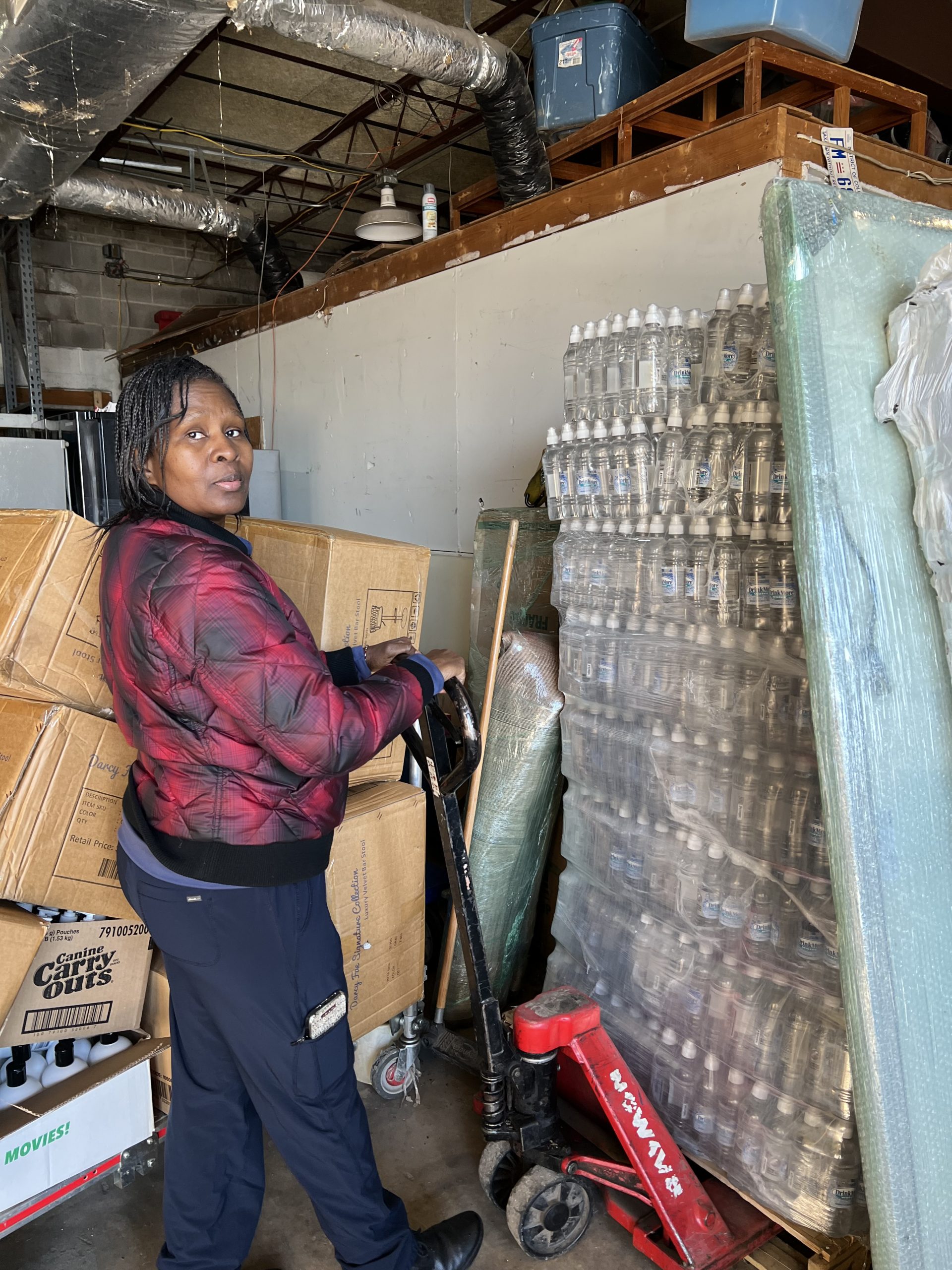 MACONA CEO Mimi Williams preparing pallets of clean water for shipment to West Africa