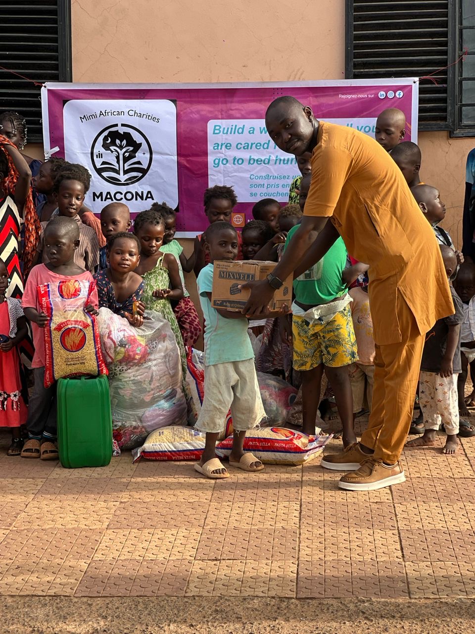 Volunteer giving food to a child at the orphanage
